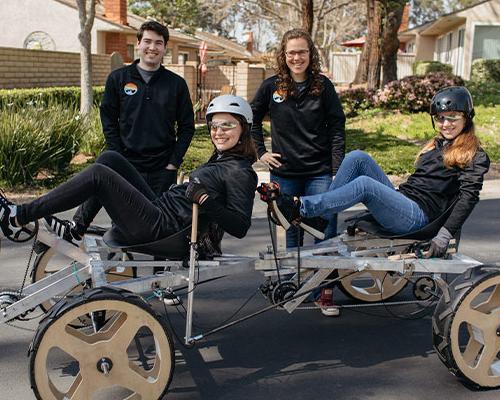 Students posing with the rover